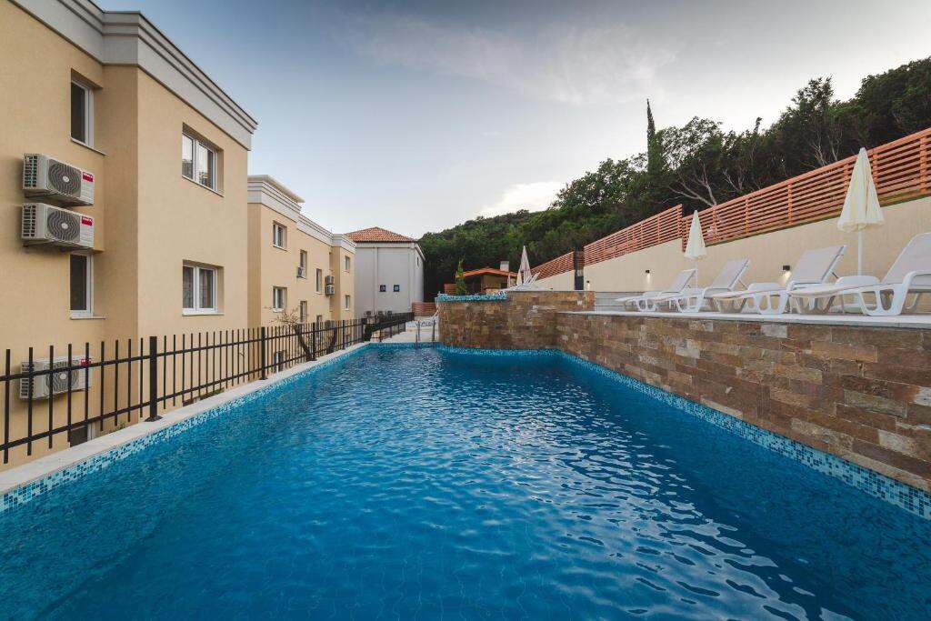 Second outdoor swimming pool and loungers at Villas Promis