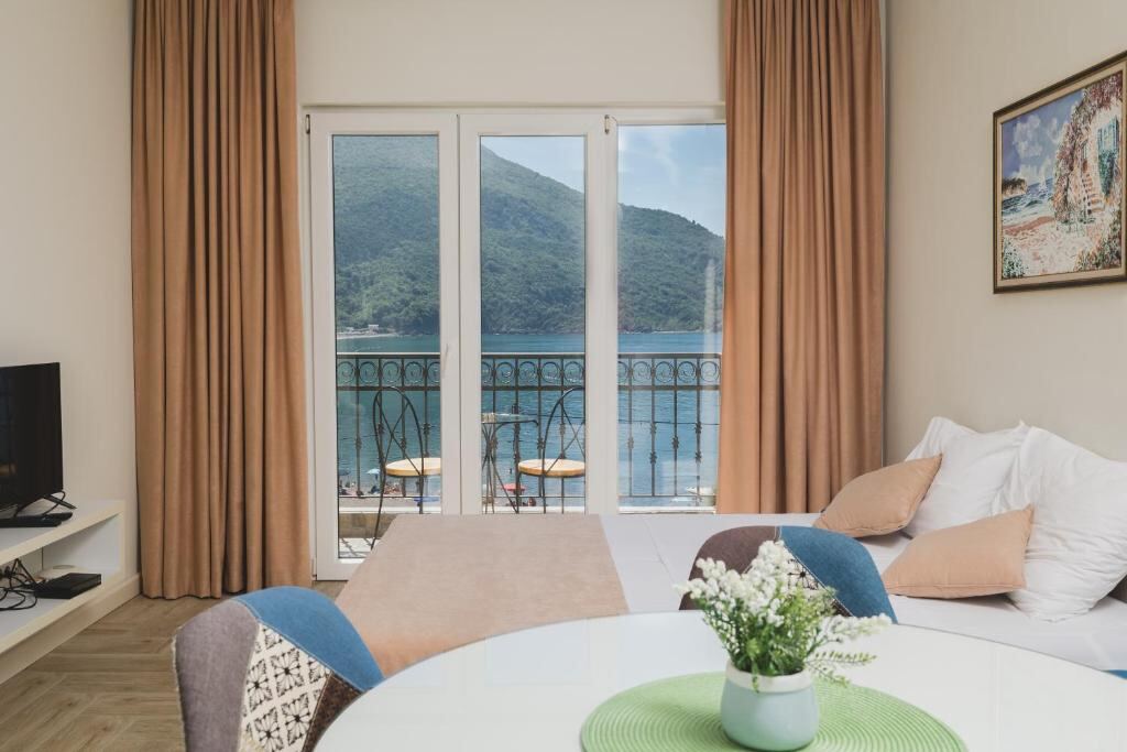 Living and dining area with sea view balcony in a sea view apartment